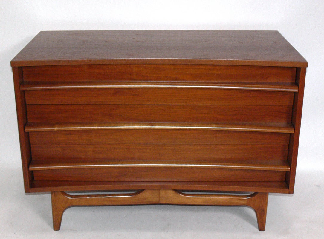 Curved Front Mid Century Modern Chest, American, circa 1950's. Beautifully grained walnut. This chest has three drawers that offer a large amount of storage in a small footprint. It is a versatile size and can be used as a chest or dresser in a