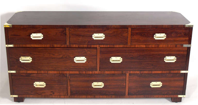 Pair of Large Rosewood Campaign Chests, circa 1960's. These chests are a large scale size and offer a voluminous amount of storage with the eight deep drawers. They are a versatile size and can be used as a chest or dresser in a bedroom, or as a