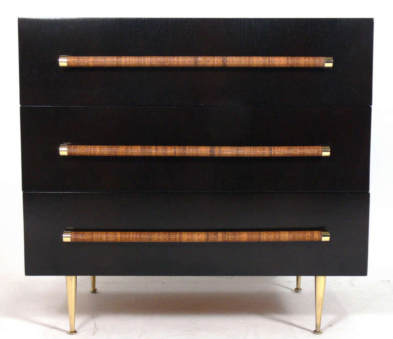 Modern Chest with Reed Wrapped Handles and Brass Hardware, designed by T.H. Robsjohn Gibbings for Widdicomb, circa 1950's. This piece has been refinished in an ultra deep brown lacquer and the brass hardware has been hand polished and lacquered.