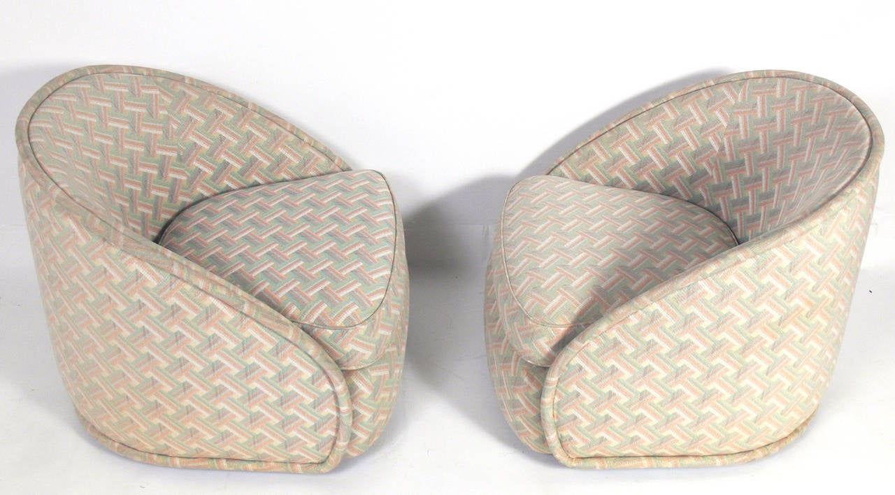 Pair of curvaceous Modern swivel lounge chairs, designed by Milo Baughman for Thayer Coggin, circa 1960s. Signed with Thayer Coggin label under cushion. These chairs are currently being reupholstered. The priced noted below includes reupholster in