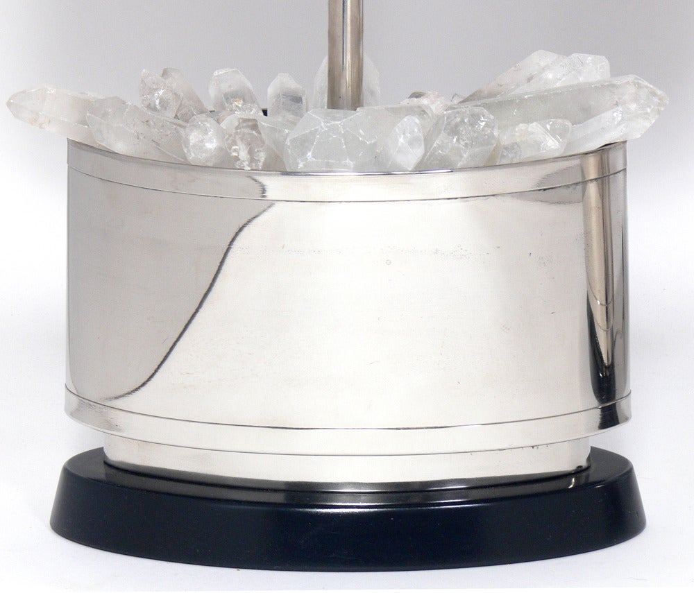 Pair of elegant nickel-plated rock crystal lamps, circa 1960s. The rock crystals emit a warm glow when the lamps are lit. They have been polished, bases refinished, and rewired and are ready to use.