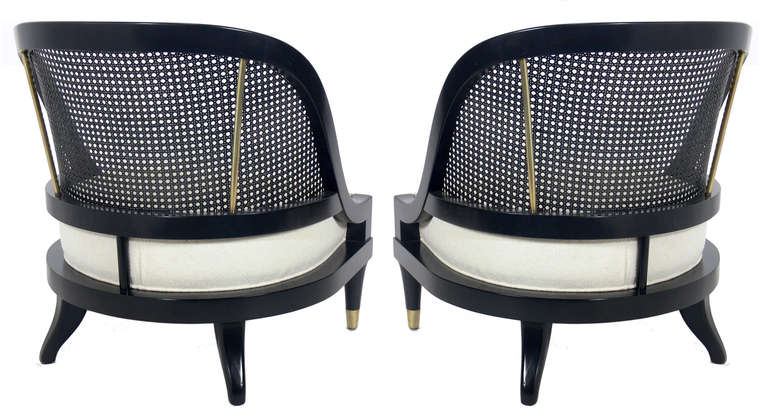 Pair of Curvaceous Black Lacquer and Brass Slipper Chairs, American, circa 1950's. They have been completely restored in a black lacquer finish with the brass hand polished and lacquered, and the seats reupholstered in an ivory boucle fabric.