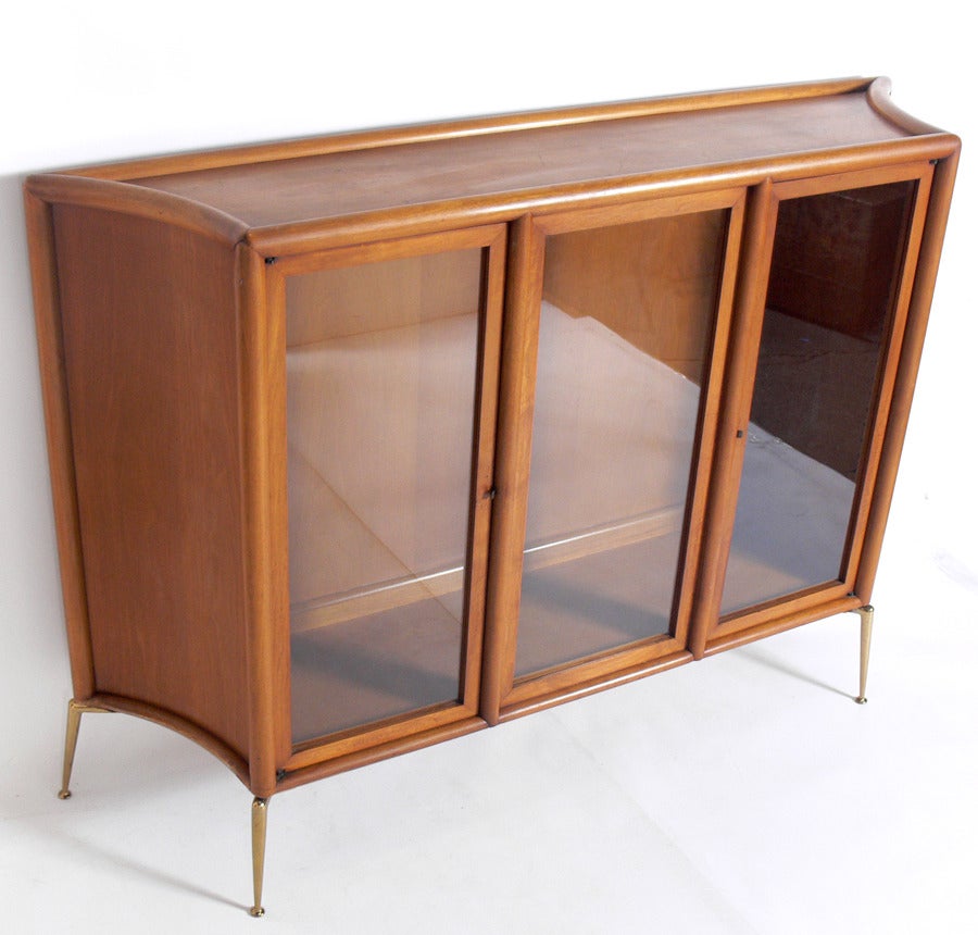 Bookcase or Vitrine Cabinet, designed by T.H. Robsjohn-Gibbings for Widdicomb, American, circa 1950's. 
This piece is a versatile size and can be used as a bookcase, vitrine, or display case. It has two adjustable glass shelves which were not
