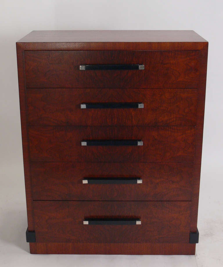 Art Deco tall chest or dresser, designed by Donald Deskey for his own company, AMODEC, circa 1930's. The exotic burled wood has incredible graining, with black lacquer trim and nickel plated hardware. Completely restored and ready to use.