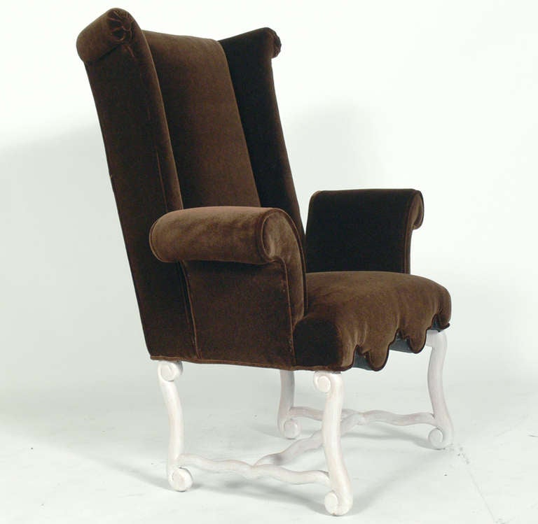 Pair of Early Wing Back Chairs, French or American, at least circa 1930's, probably earlier. They have been completely restored in a chocolate brown color mohair upholstery with an ivory strie finish to the curvaceous wooden legs. The price noted in