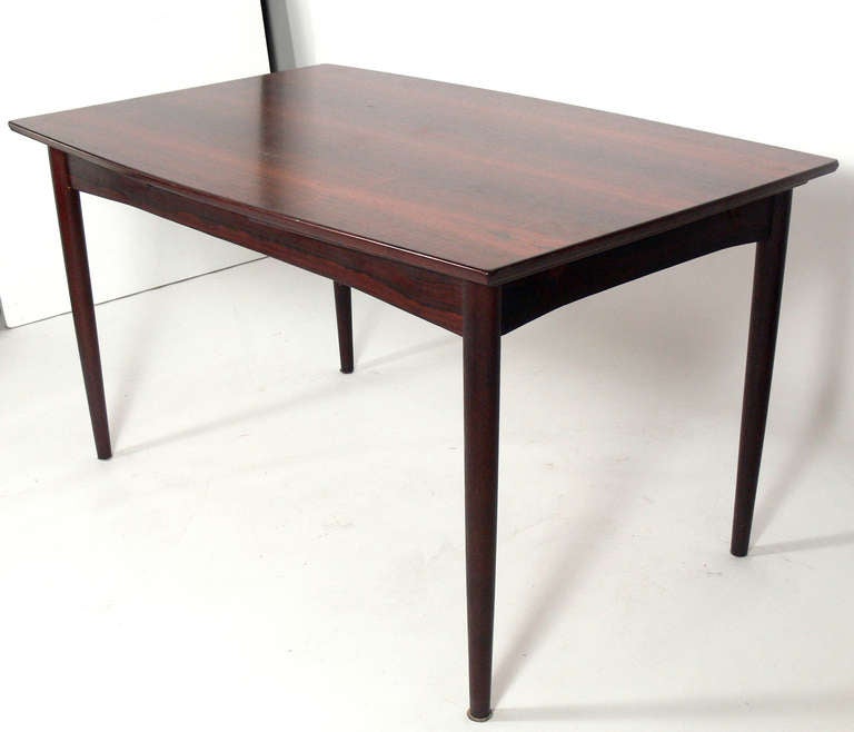 Danish Modern Rosewood Expanding Dining Table, manufactured by Dyrlund, circa 1960's. The rectangular table measures 53