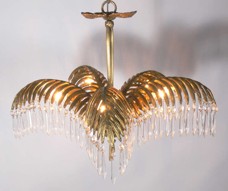 Glamorous Brass Palm Frond Chandelier, probably Italian, circa 1960's. Retains warm original patina. It has been rewired and is ready to use. The chandelier measures 21"H from the top of the brass ring seen in the first photo to the brass