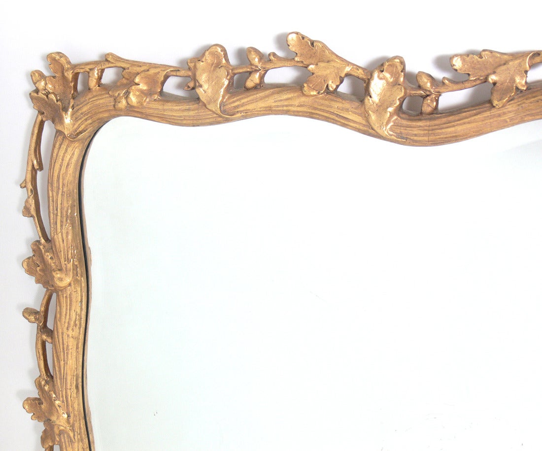 Large Scale Gilt Oak Leaf Branches Mirror, American, circa 1940's. Wonderful patina to both gilt frame and original mirrored glass.