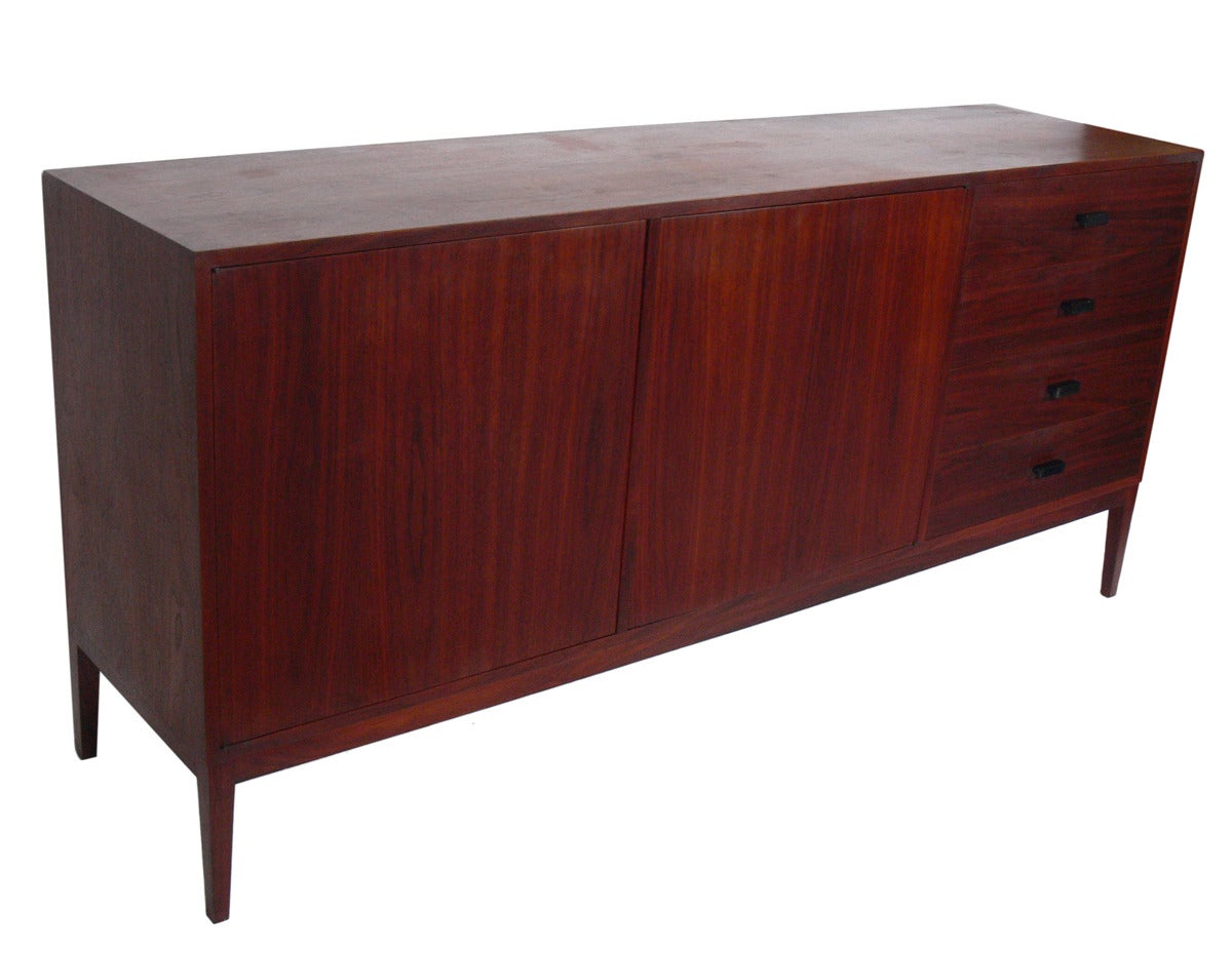 Clean Lined Danish Modern Credenza or Chest, circa 1960's. Expressively grained walnut with minimalist black handles. This piece is a versatile size and can be used as a credenza or media cabinet in a living area or as a chest or dresser in a
