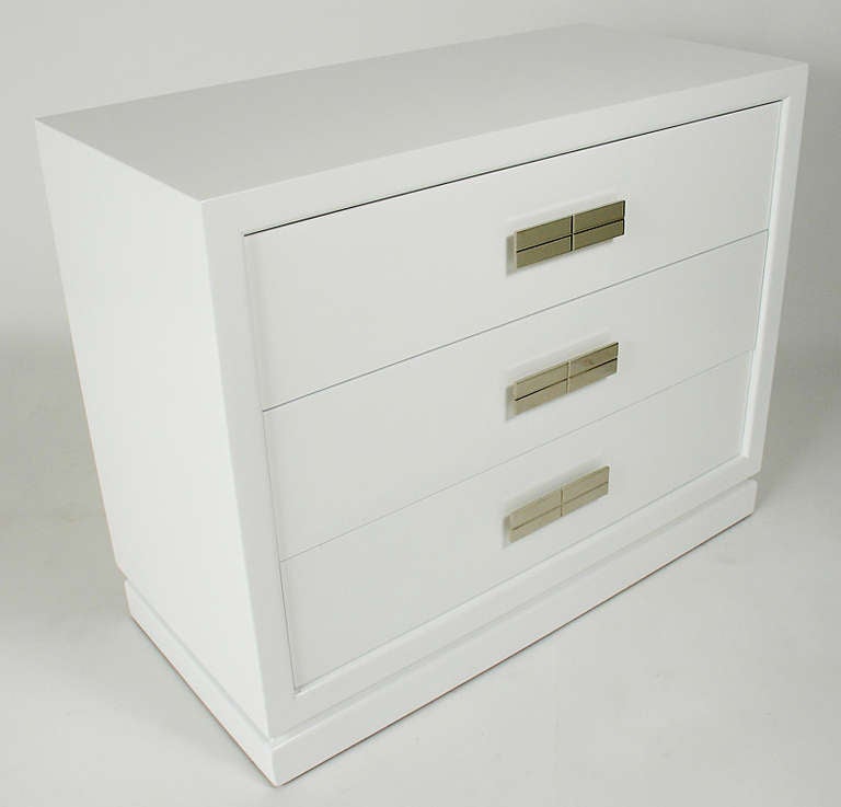 Pair of Chests in White Lacquer with Nickel Hardware, American, circa 1940s. These chests are a versatile size and can be used in a bedroom as dressers or chests, or in a living area for storage. They have been completely restored in a white color