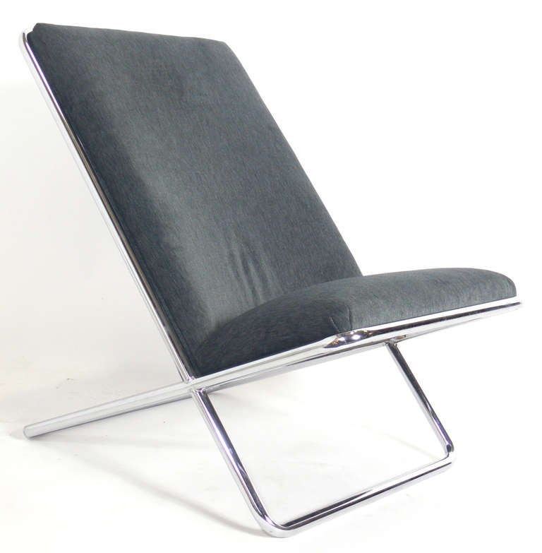 Sleek Chrome Lounge Chair, designed by Ward Bennett for Geiger, circa 1980's. It has been recently reupholstered in a charcoal gray faux velvet. The chrome frame has been hand polished.