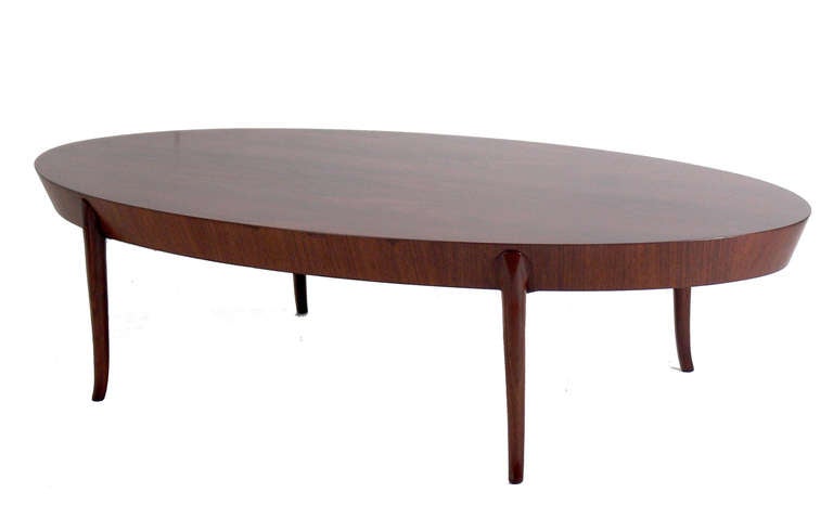 Elegant Oval Coffee Table, designed by T.H. Robsjohn Gibbings for Widdicomb, circa 1950's. Clean lined, elegant design. Refinished and ready to install.