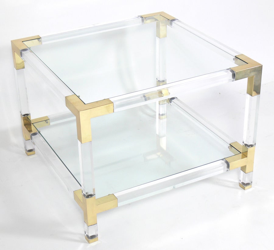Pair of Lucite and Brass End Tables, in the manner of Charles Hollis Jones, circa 1970's. They have been hand polished with the brass elements hand polished and lacquered. They are a versatile size and can be used as side or end tables, or as night