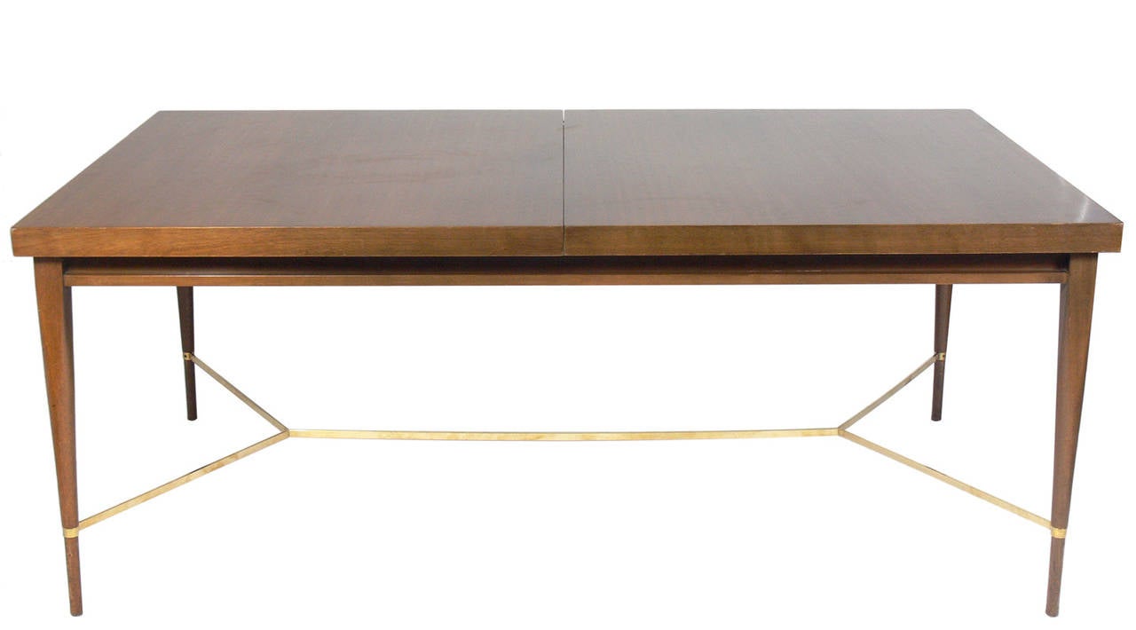 Modern Dining Table, designed by Paul McCobb for Calvin, circa 1950's. Signed with manufacturer's label underneath. This table is a versatile size and can seat from 6-12 people. With it's two leaves installed it measures an impressive 102