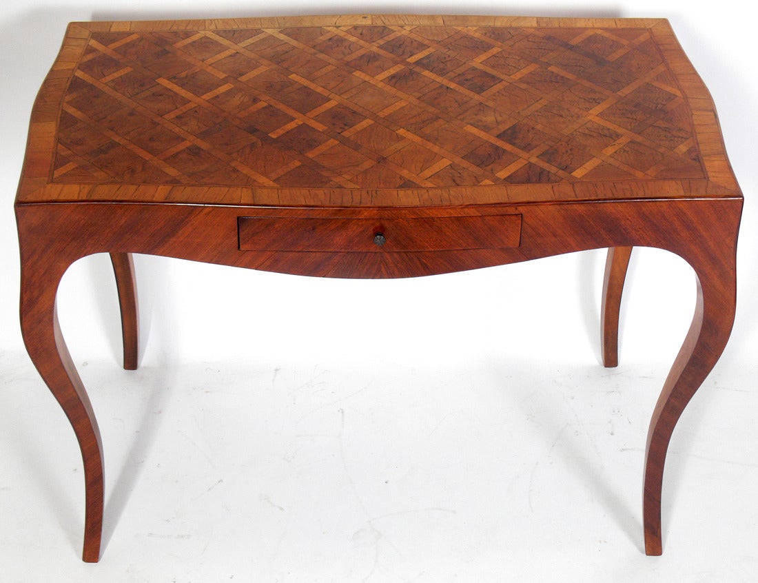 Italian Parquetry Desk with Curvaceous Legs, Italy, circa 1950's. This piece is a versatile size and could function as a desk, vanity, or console table. Retains original warm patina to wood and brass drawer pull.