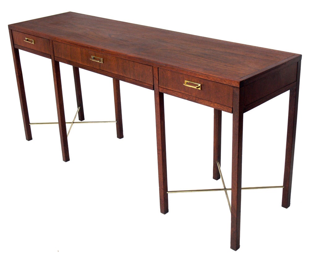 Clean Lined Walnut and Brass Console Table, American, circa 1960's. Beautiful graining to the walnut. Brass hardware and stretchers have been hand polished and lacquered. This piece is a versatile size and can be used as a console table, sofa table,