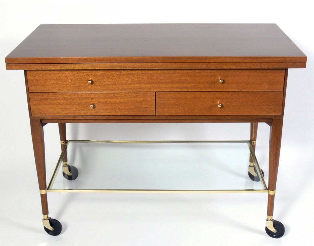 Bar or Serving Cart, designed by Paul McCobb for Calvin, circa 1950's. This is a versatile piece and can be used as a bar or serving cart, or with the top opened as a console table. When opened, the top expands to an impressive 80.5