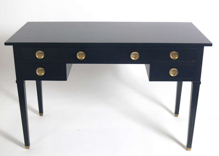 Black Lacquer Desk, designed by Tommi Parzinger for Charak. Signed with dated Charak label inside drawer, circa 1958. It has been completely restored with a new black lacquer finish and the brass hardware hand polished and lacquered. It offers a