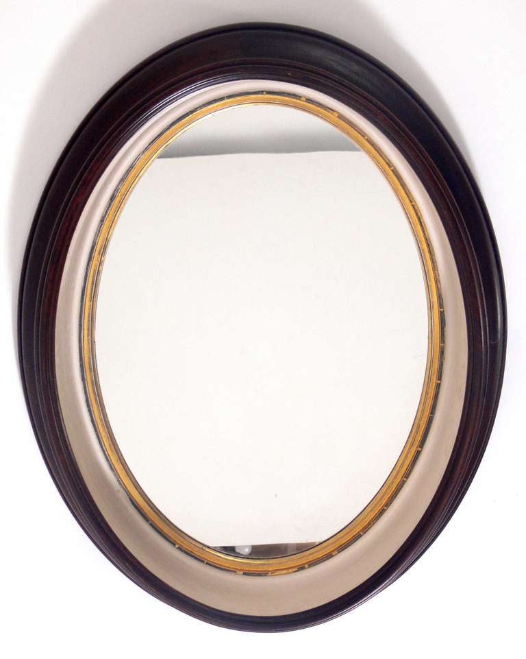 Two Antique Mahogany Porthole Mirrors, believed to be circa 1930's, possibly earlier. They retain their original warm mahogany color finish with ivory color painted and gilt interiors. Nice original patina to frames and mirrors. They are priced at