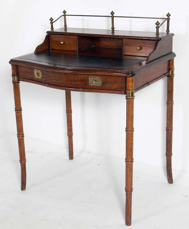 Tall Faux Bamboo Desk With Brass Hardware, American, circa 1960s. This piece is currently being refinished and can be finished in your choice of color. The price noted below includes refinishing.