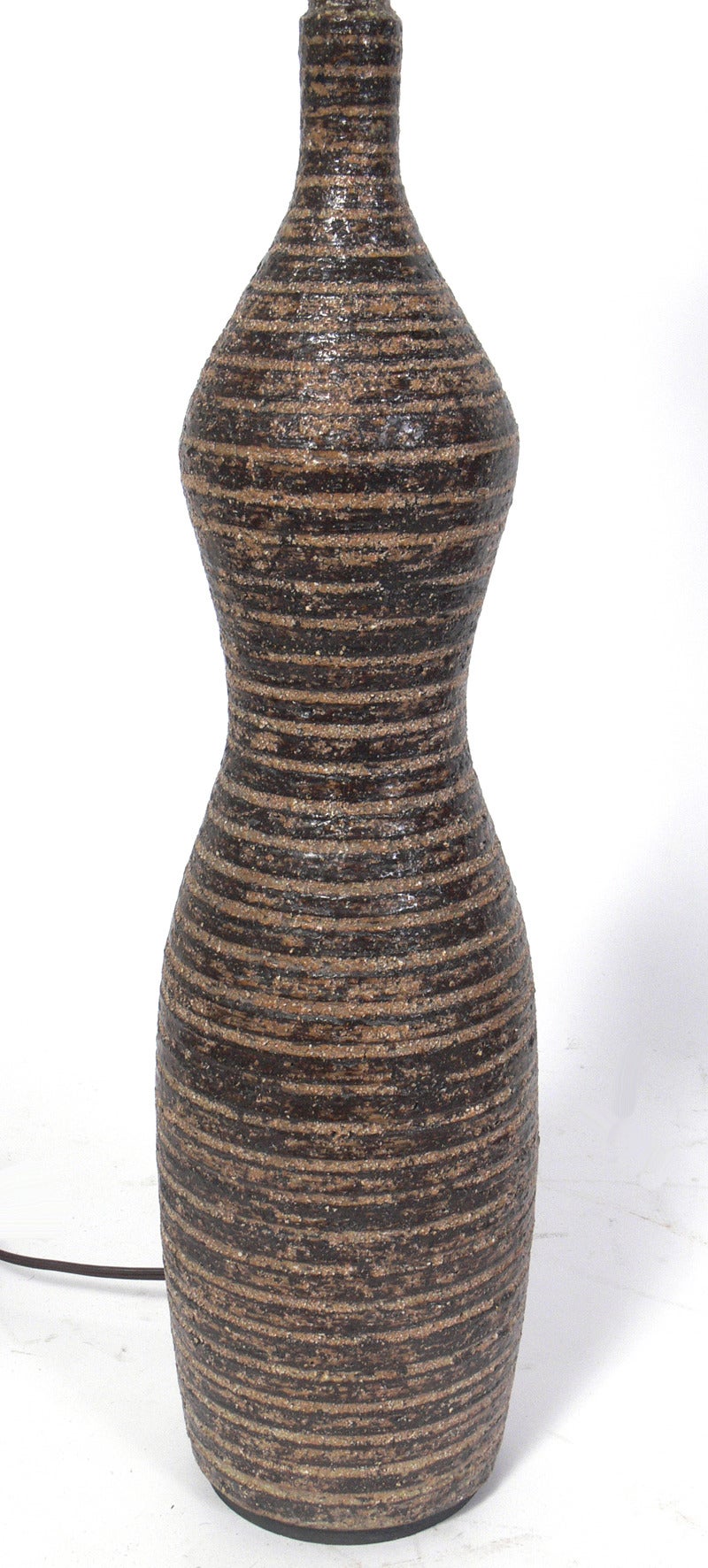 Brown ceramic bottle form lamp, attributed to Lee Rosen for Design Technics, unsigned. It measures 34.25