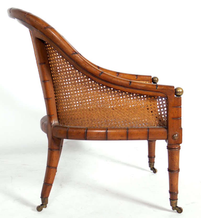 Hollywood Regency Curvaceous Caned Faux Bamboo Armchair with Brass Hardware