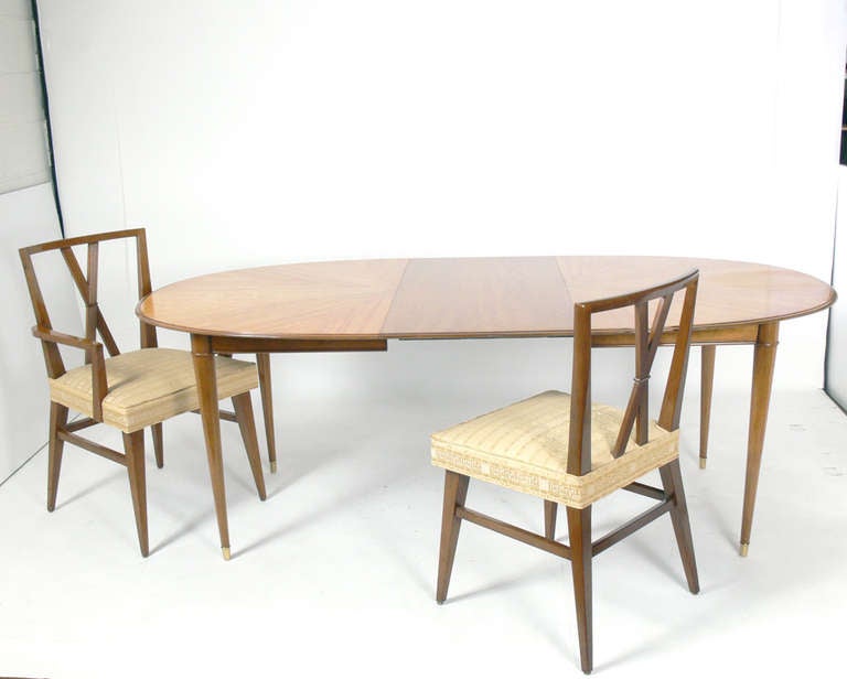 Elegant modern dining table, in the manner of Tommi Parzinger, made by Charak Modern, American, circa 1950s. Incredible graining to the bookmatched wooden top. This table is a versatile size and measures 62.25