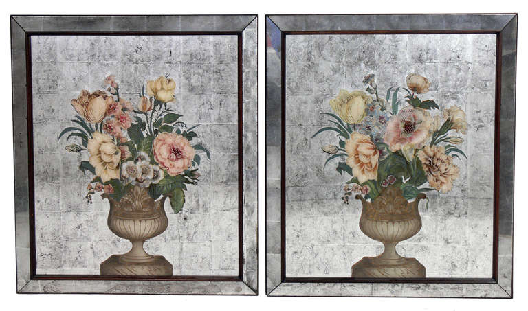 Pair of Elegant Floral Mirrors in Reverse Painted Eglomise, probably French, believed to be circa 1930's, possibly earlier. Executed in reverse painted and silver leafed glass in a wooden frame. While not exactly a mirror, the silver leafed portions