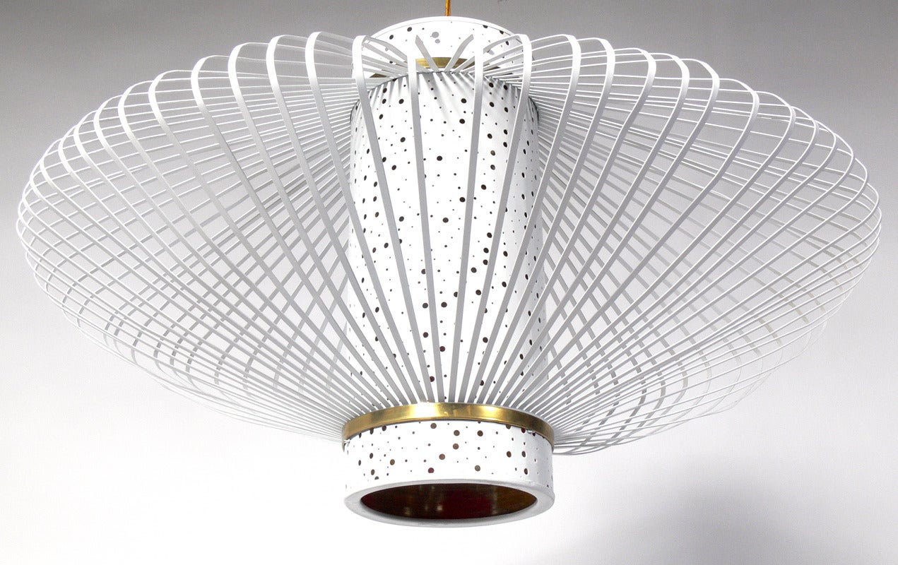 Three Modernist Chandeliers, American, circa 1950s. Very sculptural form, and nice scale. They exude a wonderful glow out of the perforated central shade. They are executed in white enameled metal with brass fittings. They are priced at $2800 each,
