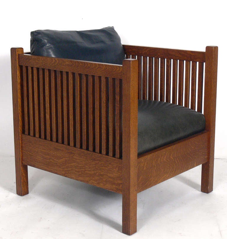 Pair of Stickley Mission Oak Cube Chairs, American, circa 1990's.
Originally designed in 1915, these examples are produced by The Stickley Company circa 1990's. They have a clean lined architectural design. They retain their original navy blue