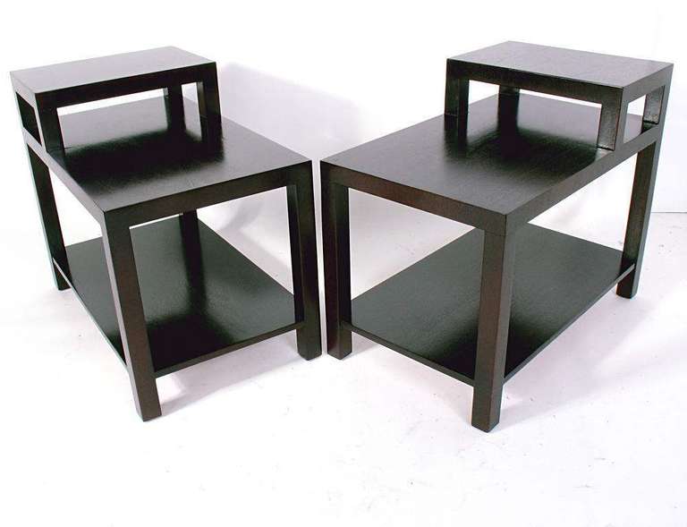 Pair of Stepped Lamp Tables, designed by T.H. Robsjohn Gibbings for Widdicomb, circa 1950's. These tables are a versatile size and can be used as end or side tables, or as nightstands. Functional stepped design allows a lamp to sit above the lower