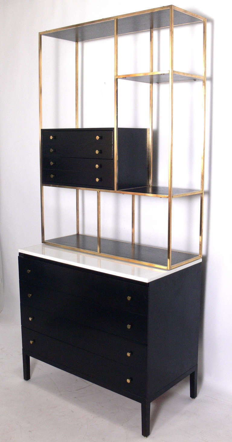 Modernist Bookshelf or Etagere, designed by Paul McCobb, American, circa 1950's. The bookshelf is a versatile piece and can be used by itself as a low bookshelf, etagere, or room divider. It is currently shown on top of a Paul McCobb chest, which is