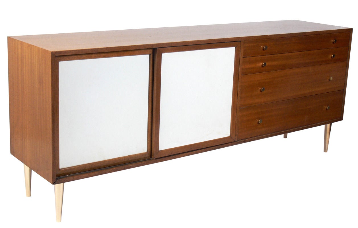 Modern Credenza designed by Harvey Probber, American, circa 1960's. It is a versatile size and can be used as a credenza, bar, or media cabinet in a living area, or as a chest or dresser in a dining room. It offers a voluminous amount of storage,