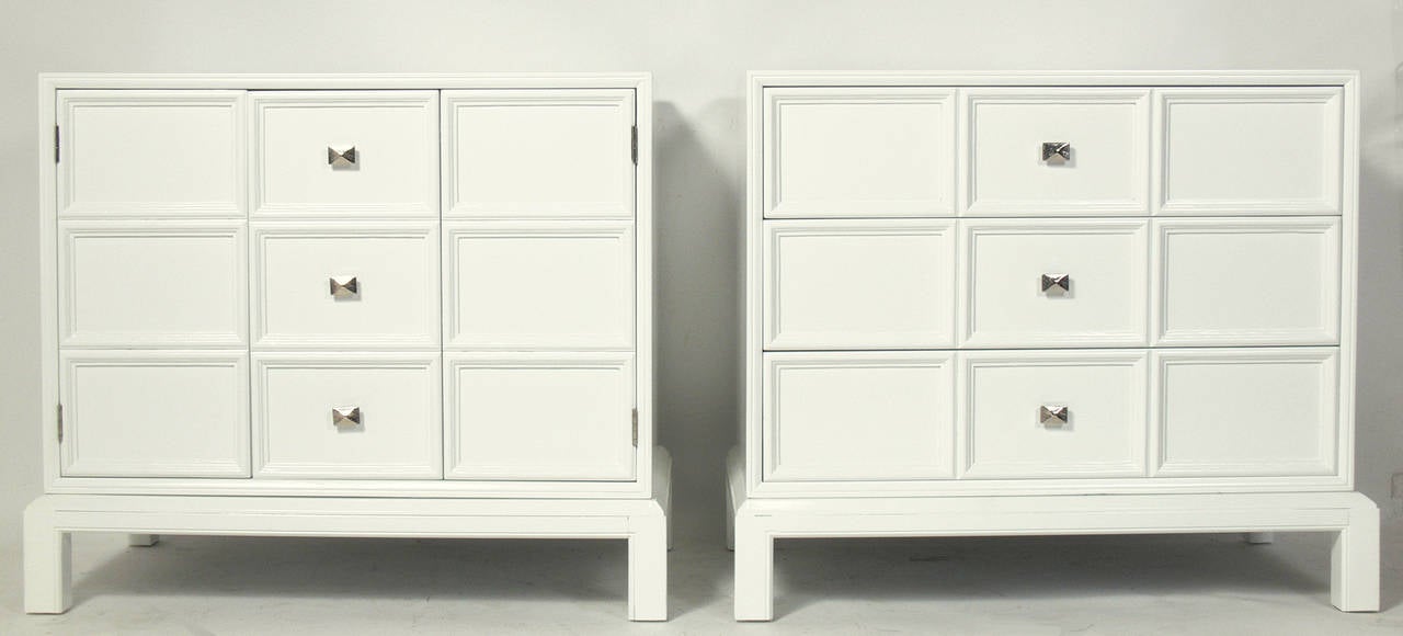 Pair of White Lacquer Chests with Nickel Hardware by Henredon, American, circa 1960s. They have been completely restored with a new white lacquer finish and newly nickeled hardware. They are a versatile pair, as one chest has three deep drawers, and