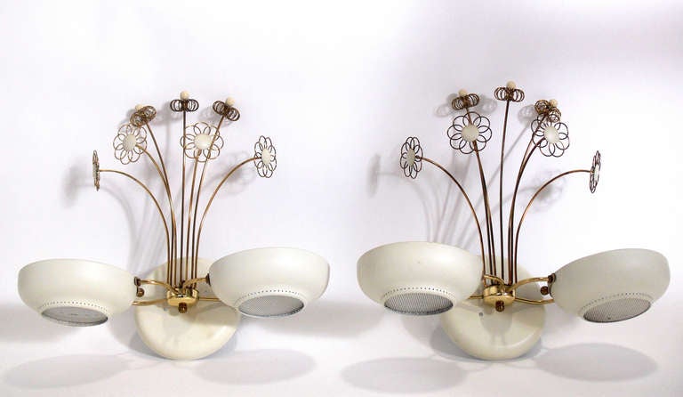 Pair of Elegant Sconces, in the manner of Paavo Tynell, circa 1950's. They retain their original ivory color lacquer finish and the brass retains it's warm original patina. They are rewired and ready to use.