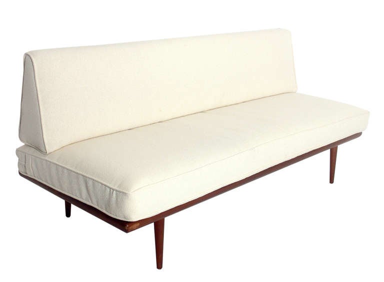 Danish Modern Settee or Sofa, designed by Peter Hvidt and Orla Molgaard-Nielsen for France and Sons, circa 1960's. This piece is currently being refinished, and the price noted below INCLUDES refinishing. It has been reupholstered in an ivory color