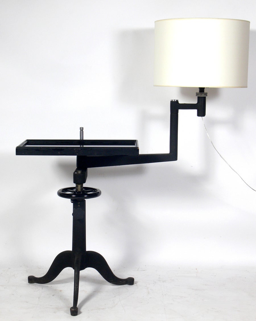 Pair of Industrial End Tables or Night Stand Lamps by Bausch & Lomb, American, circa 1930's. Originally used by an optometrist to check their client's vision, these tables have been repurposed as tables with rotating lamp arms. Perfect next to the
