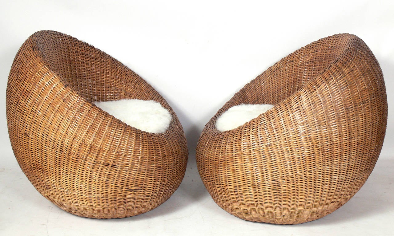Pair of Sculptural Woven Reed Chairs, designed by Isamu Kenmochi, Japanese, circa 1960's. They retain their warm original patina. Upholstered in white fur cushions.