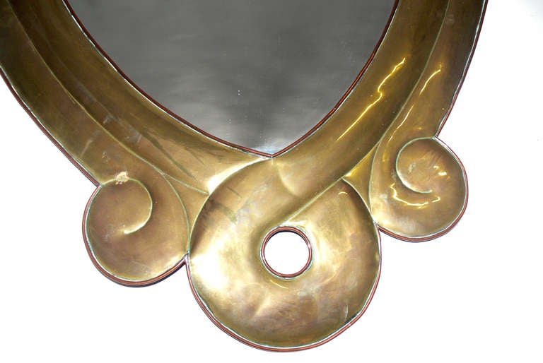 Sculptural Brass Mirror by Sergio Bustamante, Mexico, circa 1970's. Executed in brass with copper trim. It retains it's warm original patina. Signed on the back.