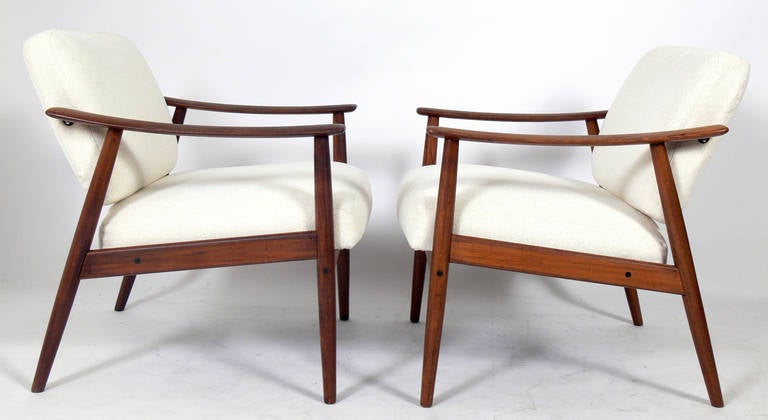 Pair of Danish modern lounge chairs, Denmark, circa 1960s. They have been reupholstered in a beige colour bouclé fabric.
