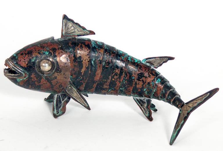 Pair of articulated fish sculptures by Graziella Laffi, Peruvian, circa 1950s. They are executed in hand-hammered copper and sterling silver. Wonderful original verdigris patina. The longer fish measures 8