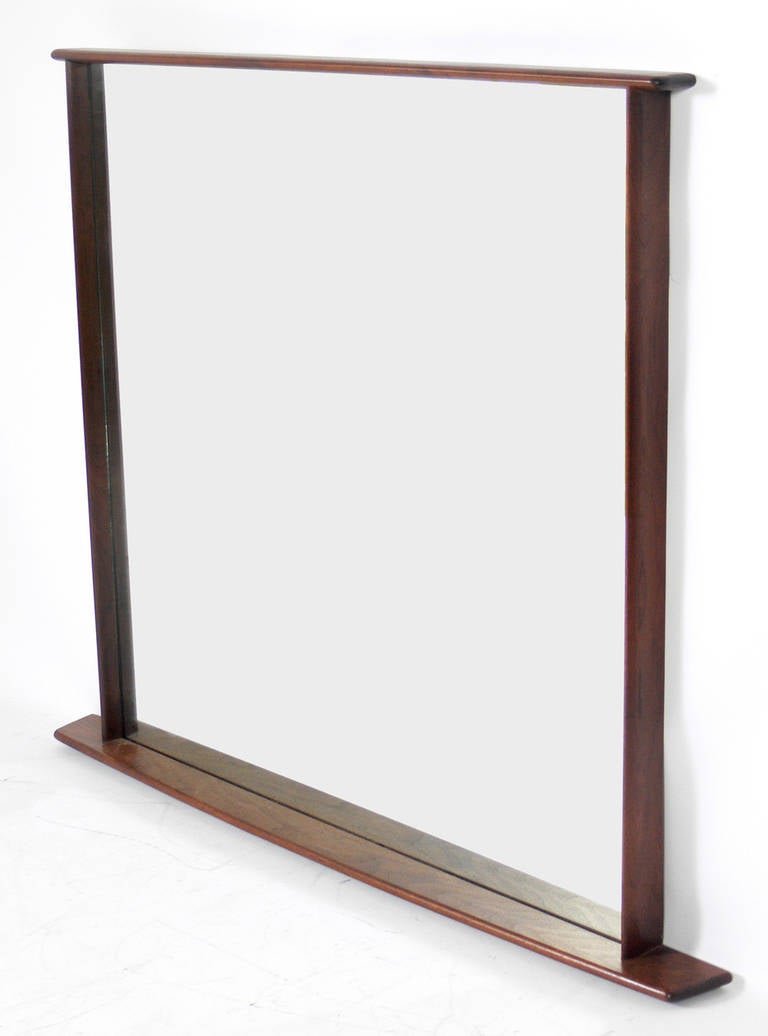 Walnut mirror, designed by George Nakashima for Widdicomb, circa 1950s. Retains warm original patina. Please see our other 1stdibs listings for the matching large-scale chest or dresser from the same estate.