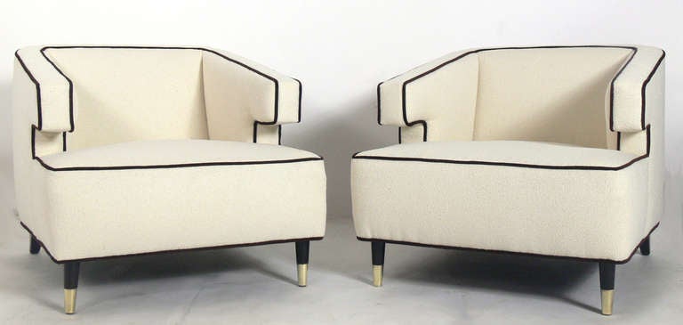 Pair of Substantial Modern Lounge Chairs with Great Lines, American, circa 1950's. They have been completely restored in an ivory boucle fabric with dark brown velvet trim and the legs finished in an ultra-deep brown color lacquer. Brass front feet