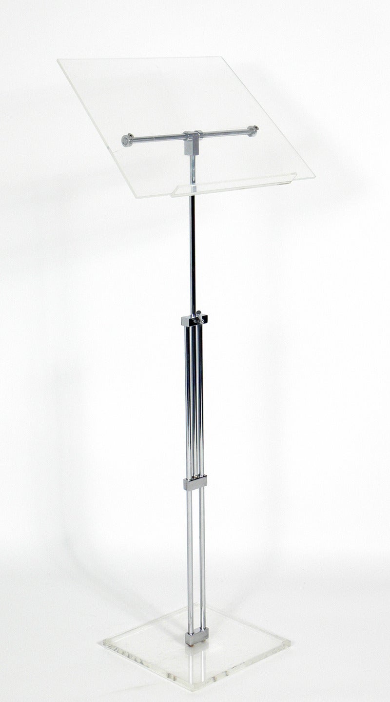 Chrome and Lucite Easel or Podium or Music Stand, American, circa 1960's. Top Lucite portion swivels and has a lip at the bottom to hold items on it. Adjustable height from 40.5