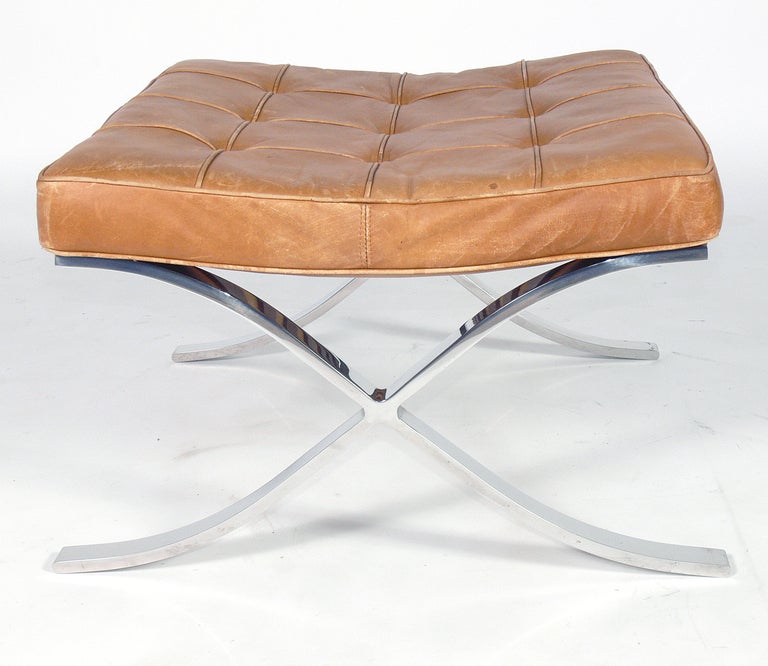 Barcelona Stool, designed by Ludwig Mies van der Rohe for Knoll, circa 1970's. This sculptural stool was designed in 1929 and has become an icon of modernist design. This example retains it's wonderfully patinated natural leather upholstery. It is a