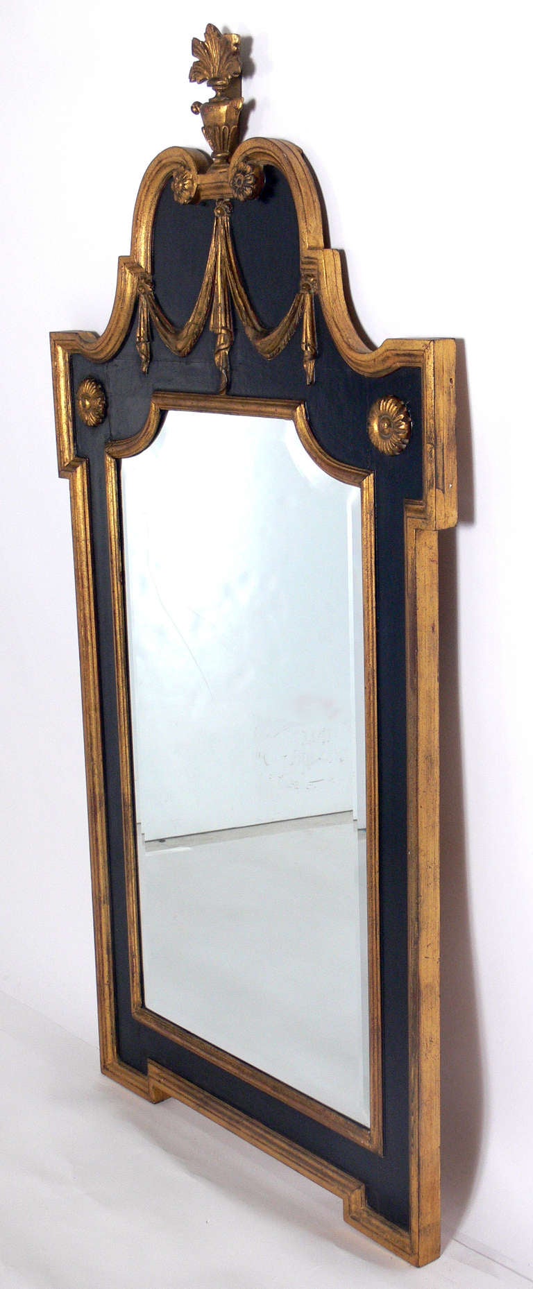 Neoclassical gold and black mirror, American, circa 1940's. Retains warm original patina to both frame and mirror.