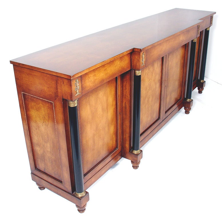 Biedermeier Style Credenza with Bronze Ormolu and Mounts, probably American, circa 1950's. It is constructed of beautifully grained walnut with black lacquered columns, gilt bronze ormolu and column mounts. It offers a voluminous amount of storage