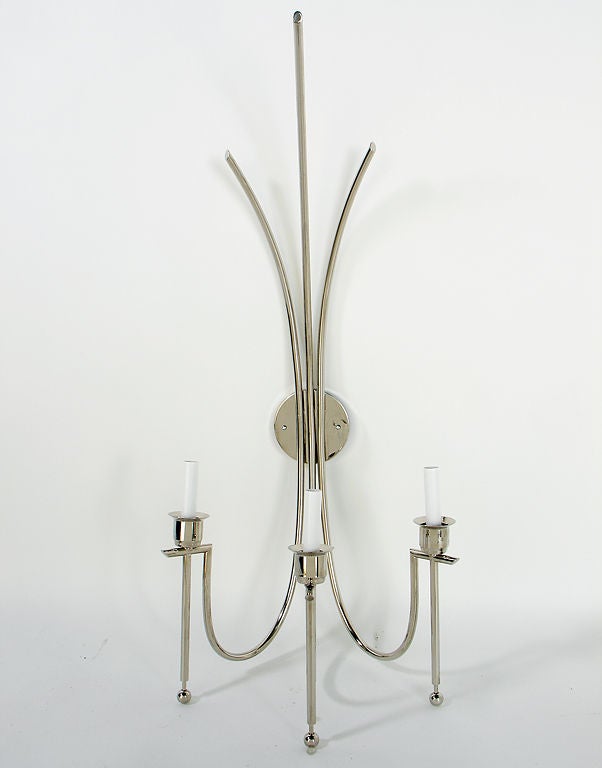 Pair of Large Scale Nickel Plated Sconces, in the manner of Tommi Parzinger, circa 1940's. They have a glamorous form, and would fit seamlessly into any interior, from traditional to ultra-modern. They have been replated and rewired and are ready to