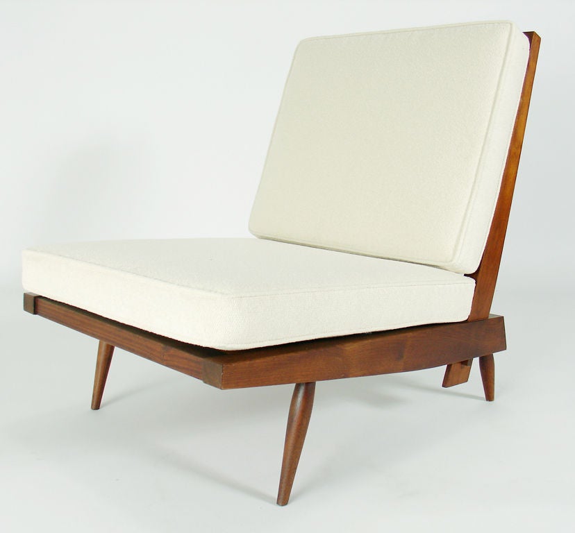 Hand Crafted Lounge Chair and Ottoman, by George Nakashima, American, circa 1960's. They have been reupholstered in an ivory color boucle upholstery. The chair measures 30