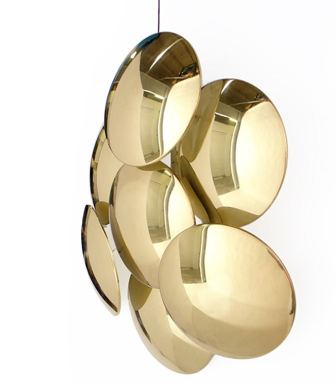 Large scale, sculptural brass wall sconce or applique, designed by Reggiani, circa 1970's. Wonderful mood lighting is emitted from the backlit discs, which cast sculptural shadows. This sconce is mounted with a standard threaded electrical box.<br